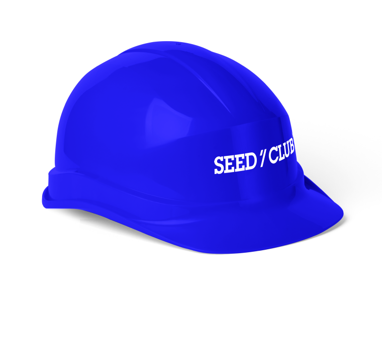 FAQ wearing a blue hardhat with the Seed Club logo on it.